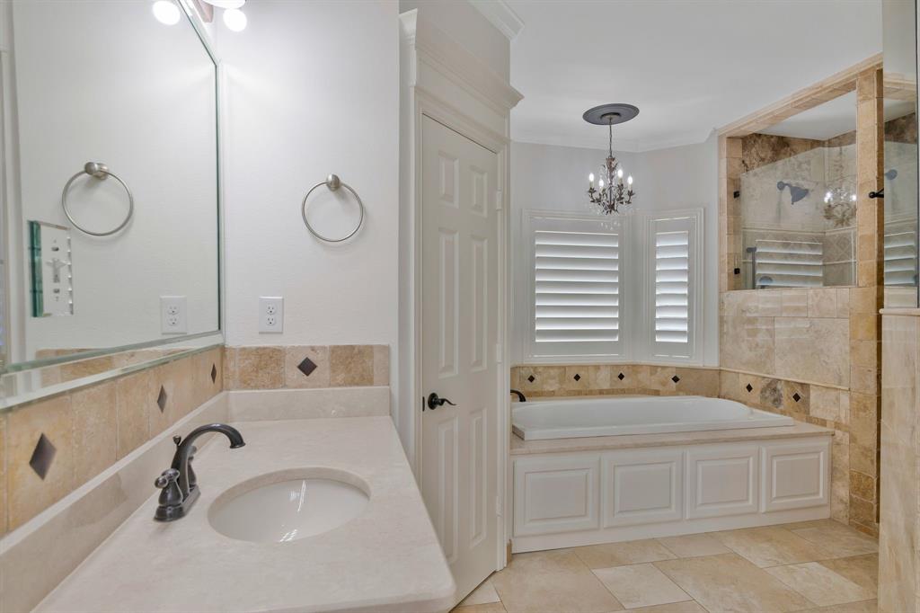1980 Gertie Barrett Road Mansfield, TX 76063 - Photo 15 of 40 a bathroom with a tub sink and mirror