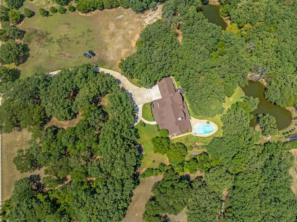 1980 Gertie Barrett Road Mansfield, TX 76063 - Photo 35 of 40 an aerial view of a house with a yard and trees all around