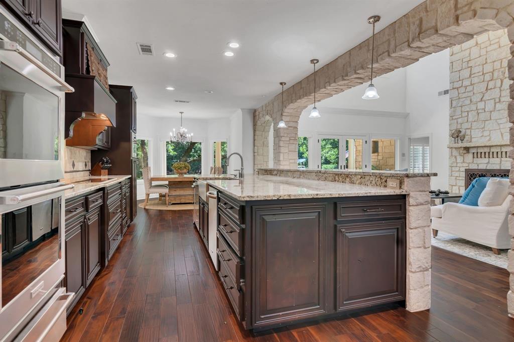 1980 Gertie Barrett Road Mansfield, TX 76063 - Photo 39 of 40 a kitchen with stainless steel appliances granite countertop a stove and a wooden floors