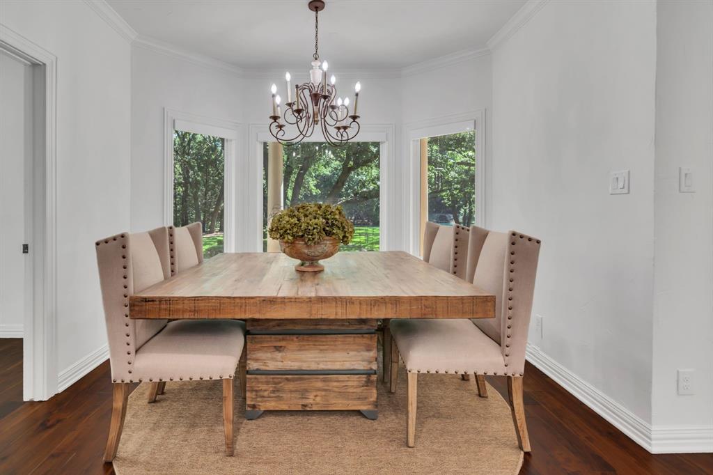1980 Gertie Barrett Road Mansfield, TX 76063 - Photo 9 of 40 a view of a dining room with furniture a chandelier and wooden floor