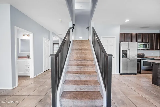 a view of a kitchen with refrigerator and microwave