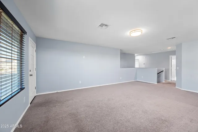 an empty room with windows and entrance