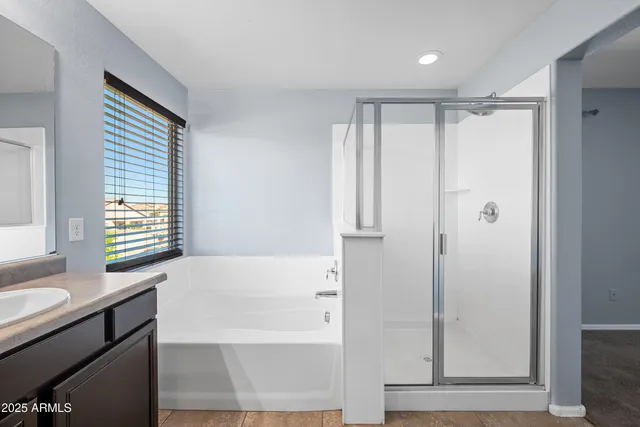 a bathroom with a bathtub and a shower