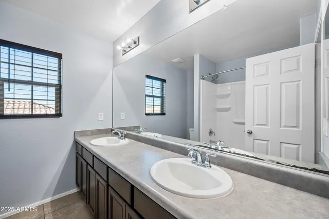 a bathroom with 2 sink and a mirror