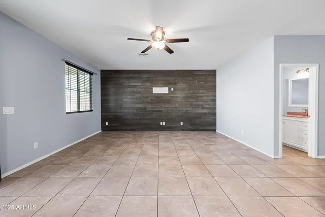 an empty room with windows and cabinet