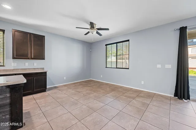 a view of an empty room with window and cabinet