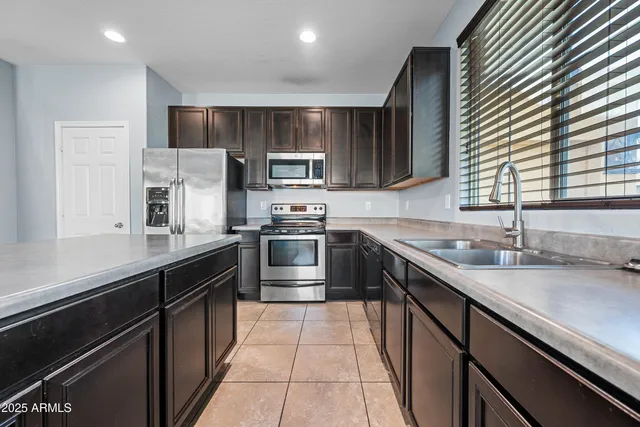 a kitchen with stainless steel appliances granite countertop a sink stove microwave and cabinets