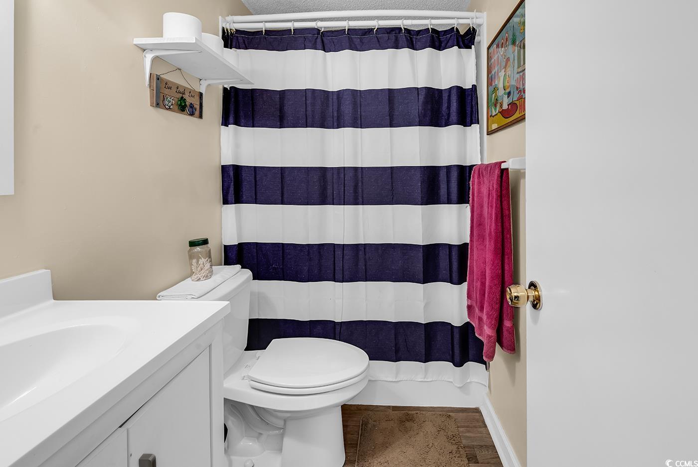 449 Rainbow Drive Murrells Inlet, SC 29576 - Photo 11 of 33 Full bath with vanity, a shower with shower curtain, and wood finished floors