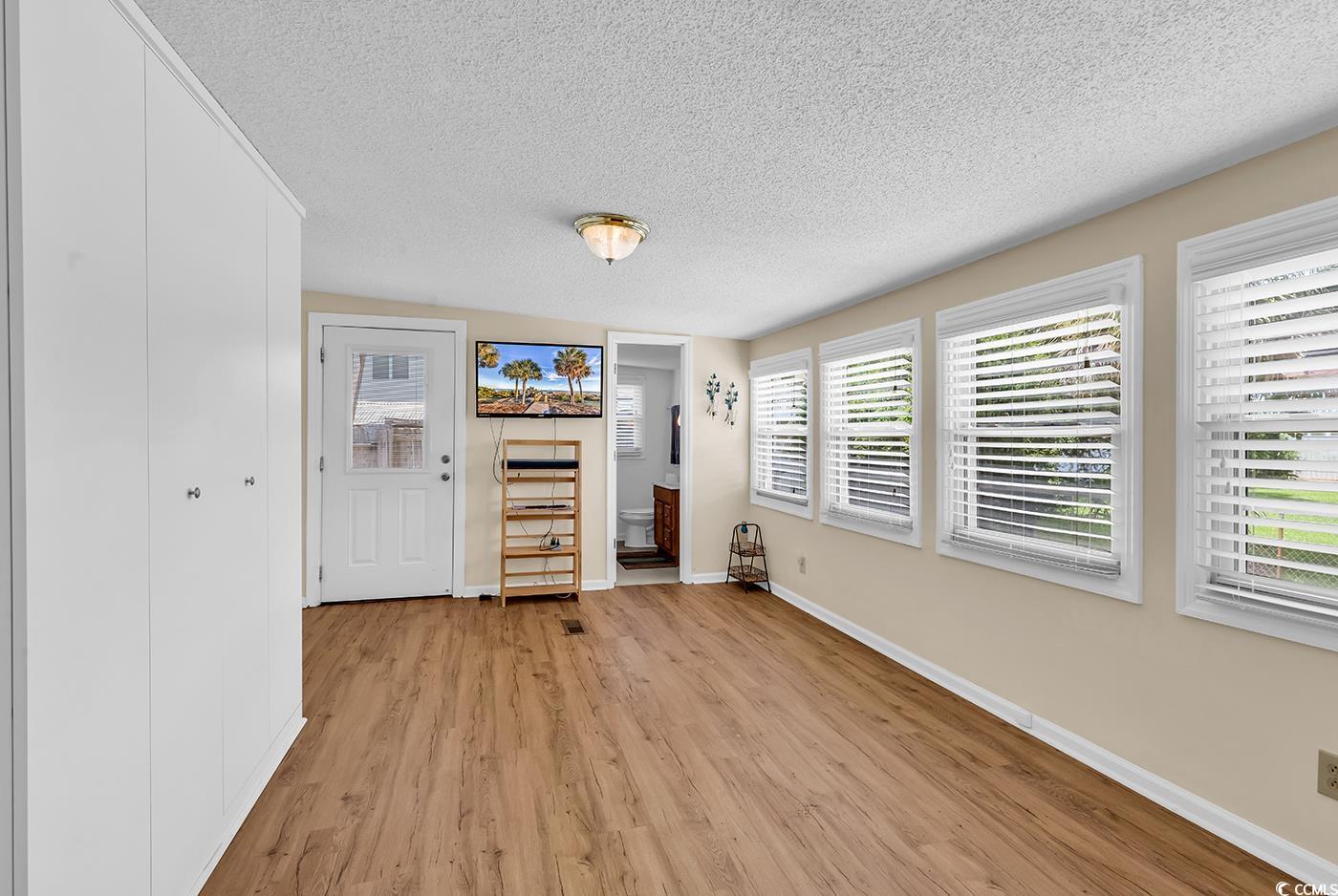 449 Rainbow Drive Murrells Inlet, SC 29576 - Photo 15 of 33 Unfurnished living room with a textured ceiling and light wood finished floors