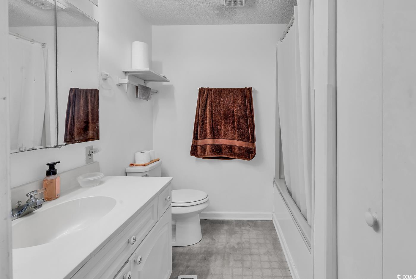 449 Rainbow Drive Murrells Inlet, SC 29576 - Photo 21 of 33 Bathroom featuring vanity, a textured ceiling, and tile patterned floors