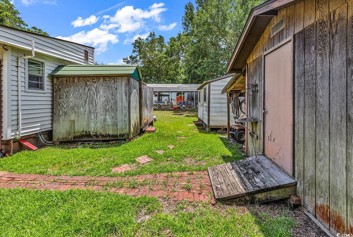 449 Rainbow Drive Murrells Inlet, SC 29576 - Photo 27 of 33 View of grassy yard with a storage unit
