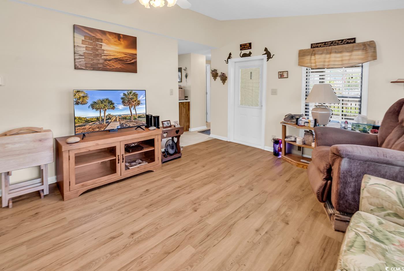 449 Rainbow Drive Murrells Inlet, SC 29576 - Photo 3 of 33 Living area featuring light wood-type flooring, vaulted ceiling, and a ceiling fan