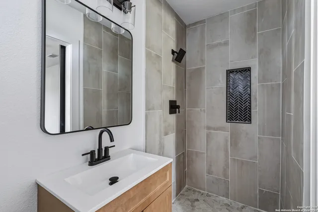 a bathroom with a sink and mirror