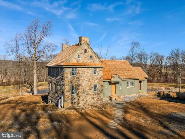 a front view of a house with a garden and yard