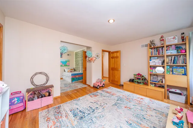 a bedroom with furniture and a book shelf