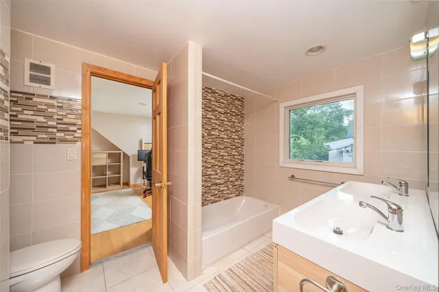 a bathroom with a bathtub and a sink