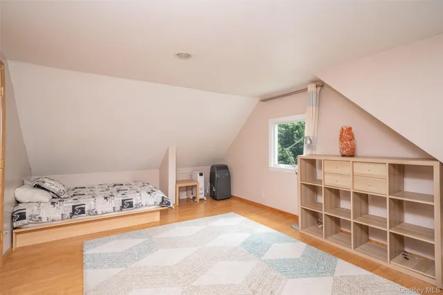 a view of a bedroom with a window and cabinet