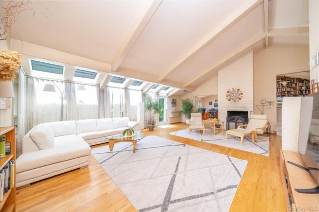 a living room with patio furniture and a fireplace