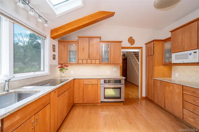 a kitchen with stainless steel appliances granite countertop a refrigerator and a sink