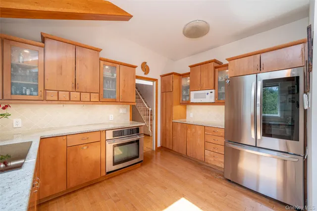 a kitchen with stainless steel appliances granite countertop a refrigerator and a stove
