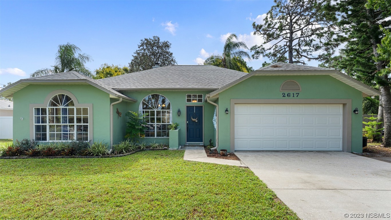 a front view of a house with a garden