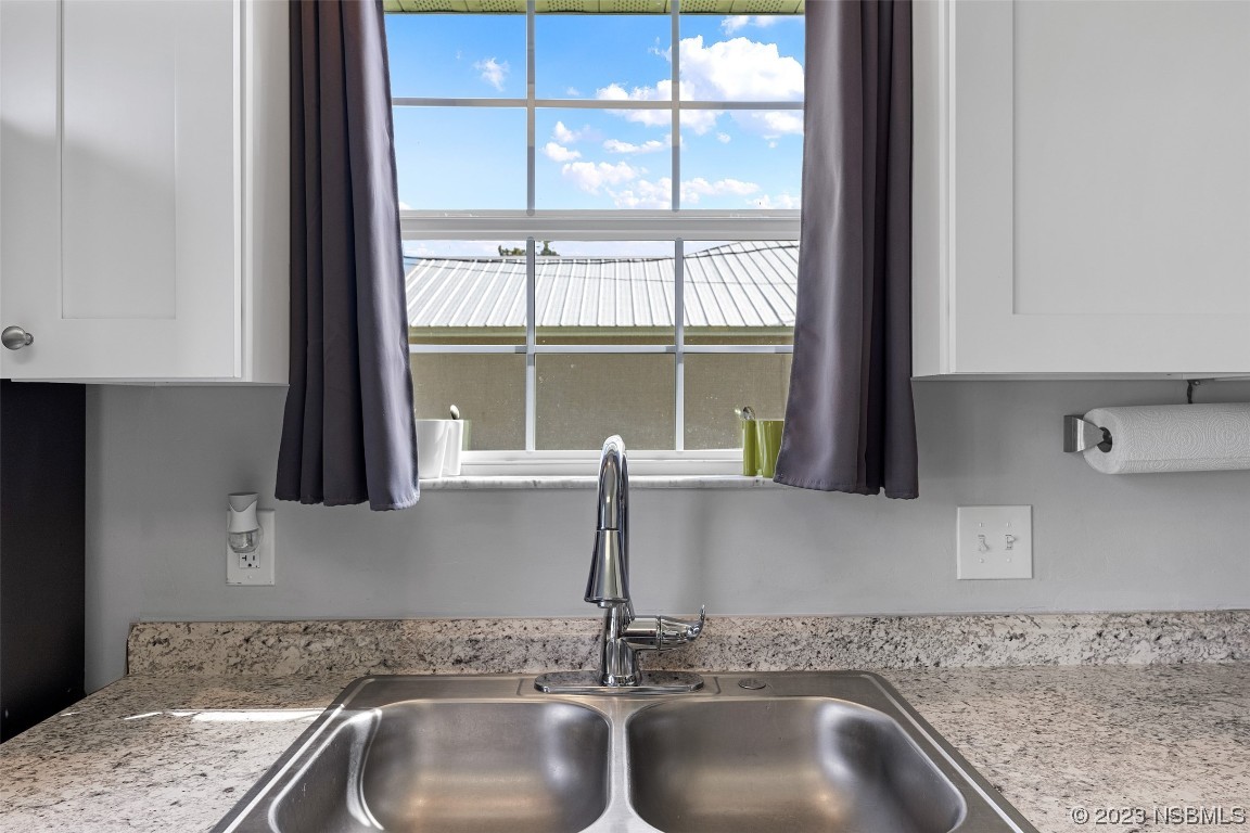 2617 35th Street Edgewater, FL 32141 - Photo 16 of 43 a kitchen with a sink and a window