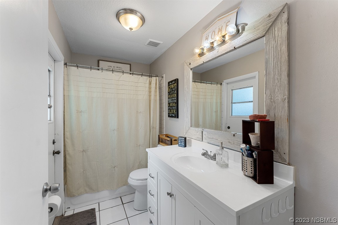 2617 35th Street Edgewater, FL 32141 - Photo 18 of 43 a bathroom with a sink a toilet and shower