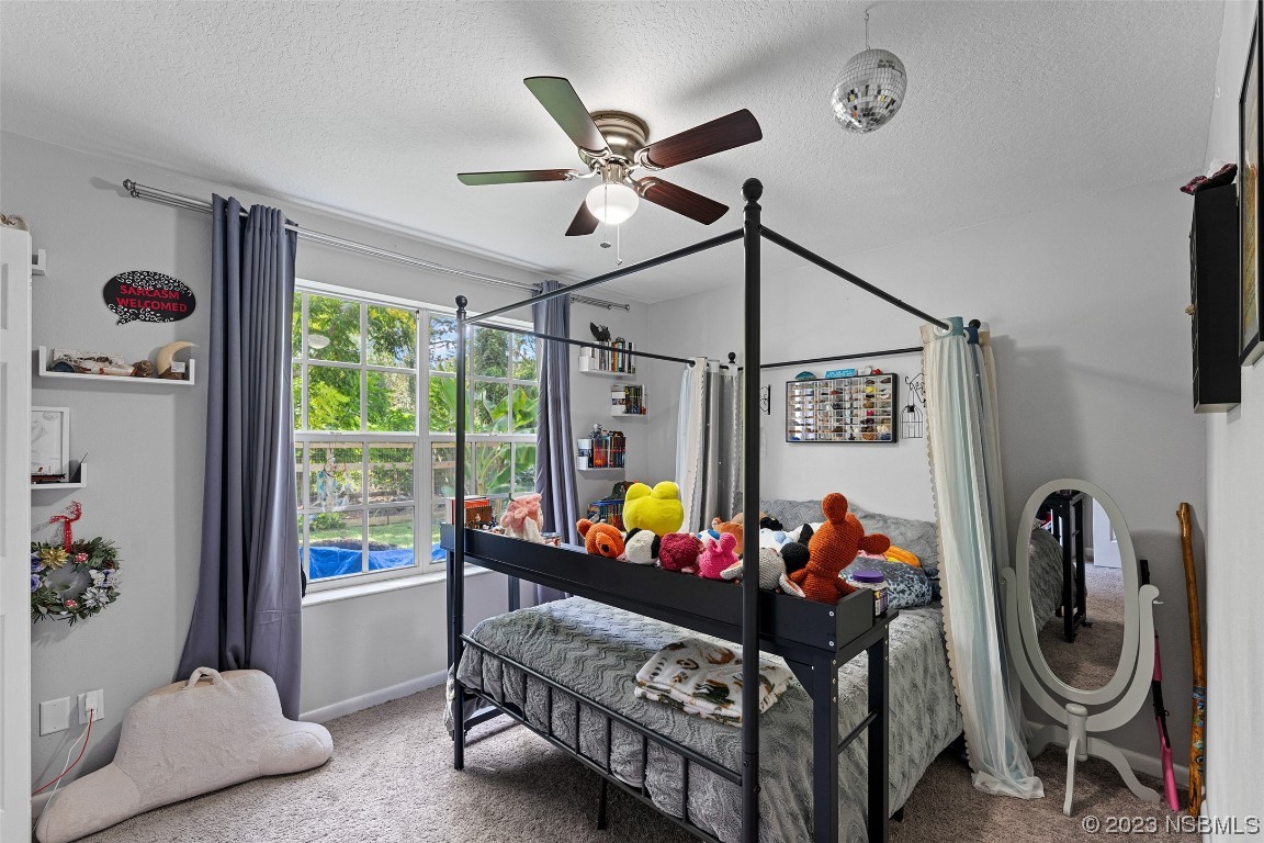 2617 35th Street Edgewater, FL 32141 - Photo 21 of 43 a bed room with furniture and a window