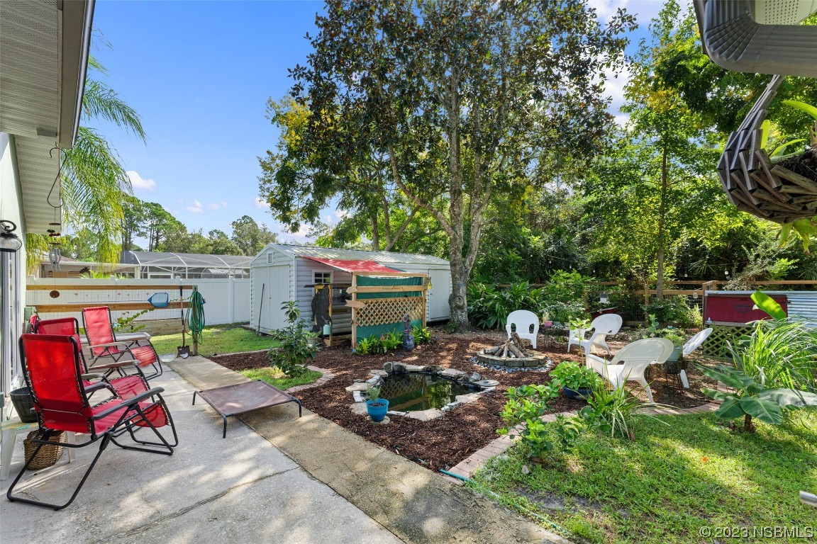 2617 35th Street Edgewater, FL 32141 - Photo 23 of 43 a view of backyard with outdoor seating and plants