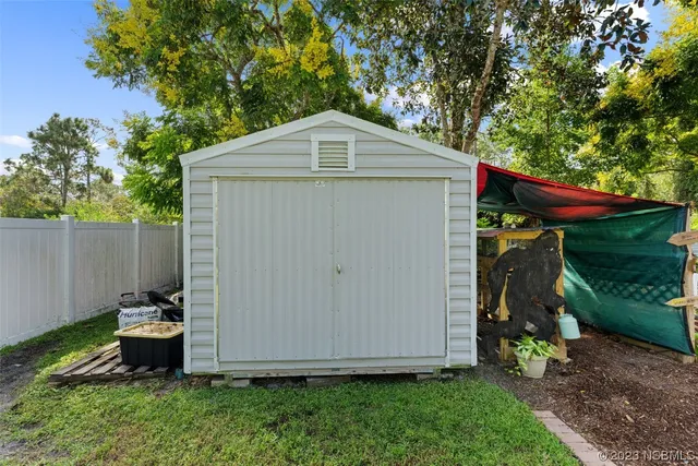 a view of a small barn in the garden