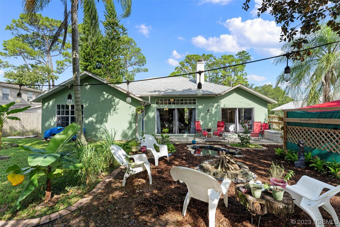 2617 35th Street Edgewater, FL 32141 - Photo 32 of 43 a view of the chairs and table in a backyard