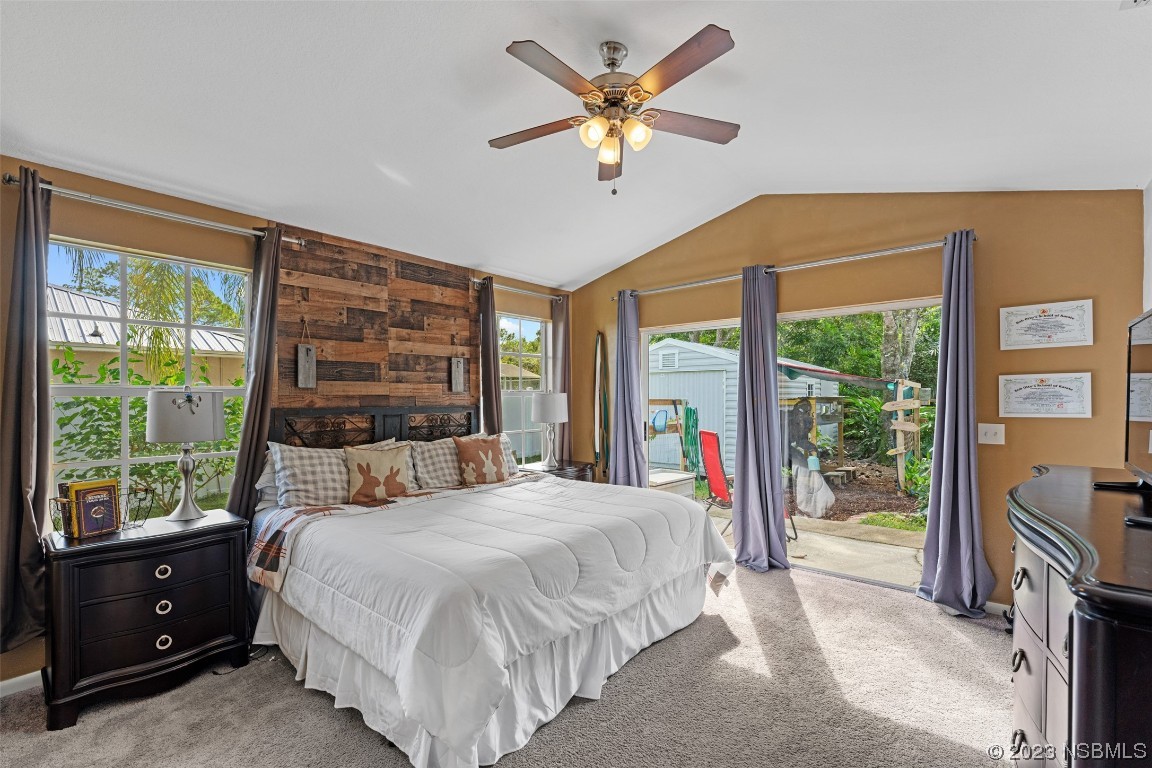 2617 35th Street Edgewater, FL 32141 - Photo 35 of 43 a bedroom with a large bed and a large window