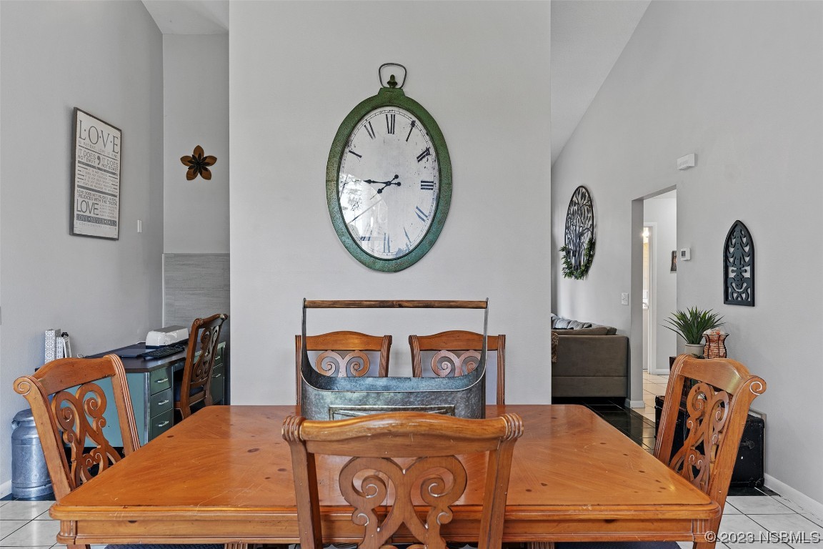 2617 35th Street Edgewater, FL 32141 - Photo 5 of 43 a bedroom with a bed a clock on the wall and a table