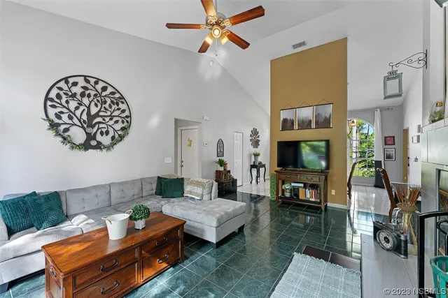 a living room with furniture a flat screen tv and a fireplace