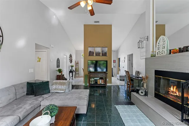 a living room with furniture fireplace and flat screen tv