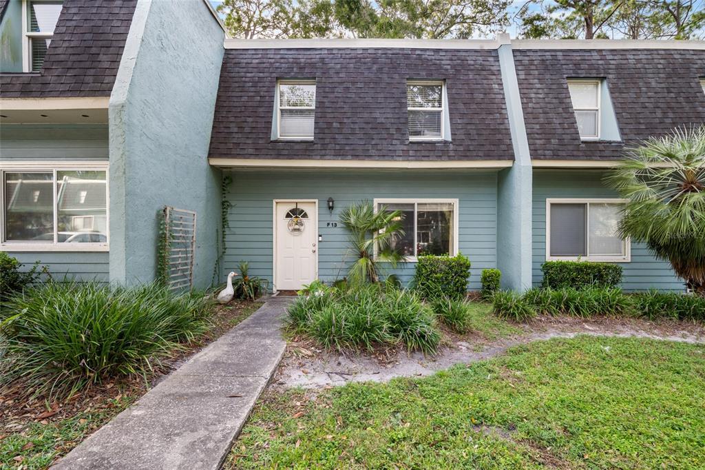 501 Southwest 75th Street, Unit F13 Gainesville, FL 32607 - Photo 1 of 1 front view of a brick house with potted plants