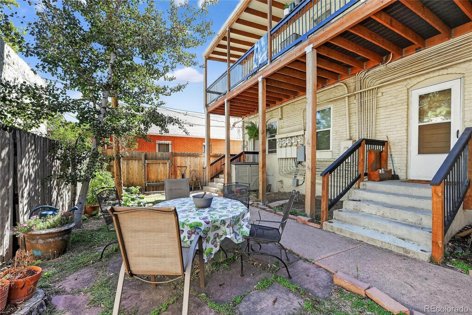 3127 West 28th Avenue, Unit 2 Denver, CO 80211 - Photo 18 of 30 a view of a patio with couches table and chairs and potted plants