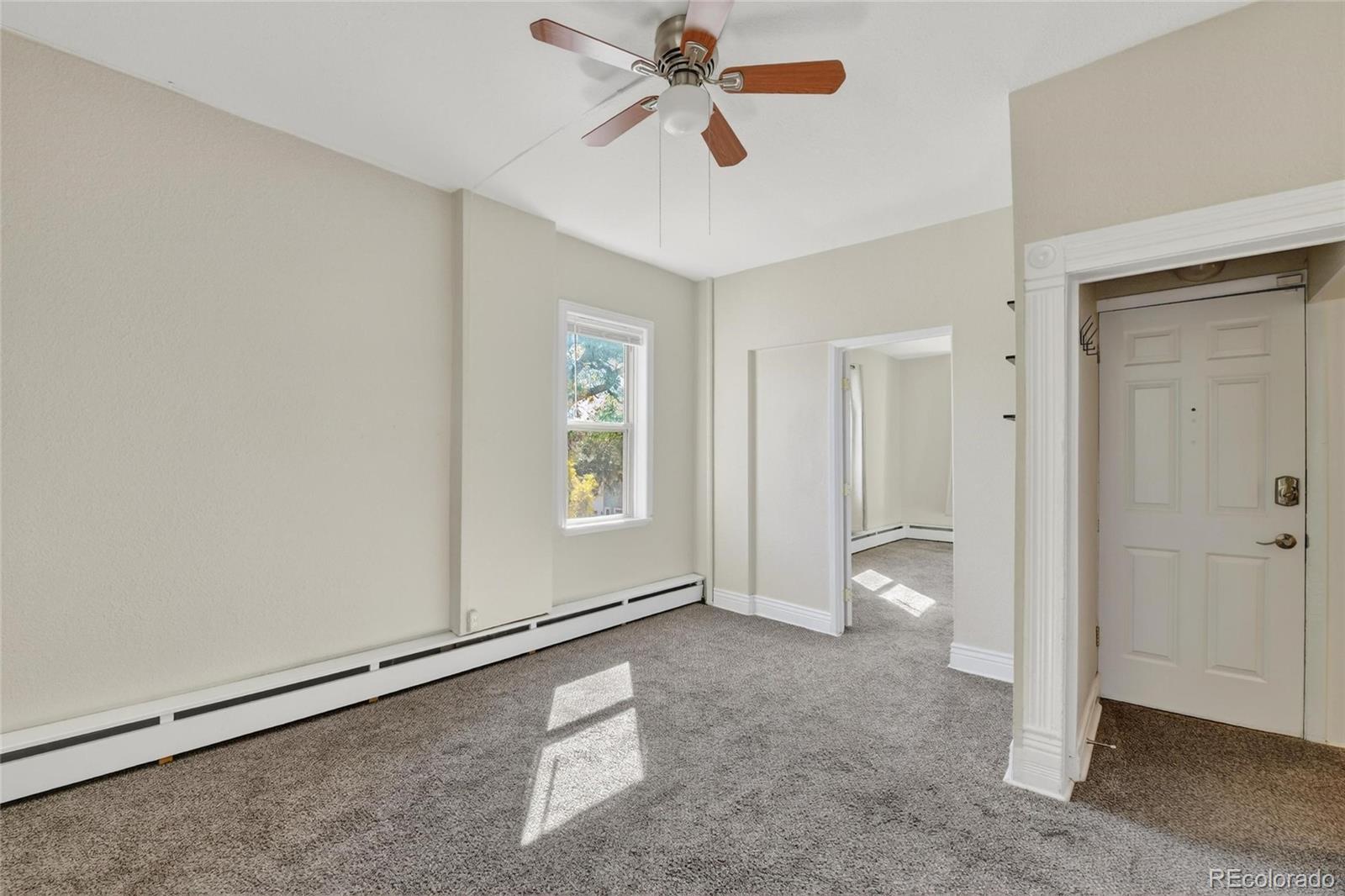 3127 West 28th Avenue, Unit 2 Denver, CO 80211 - Photo 22 of 30 a view of empty room with window and ceiling fan