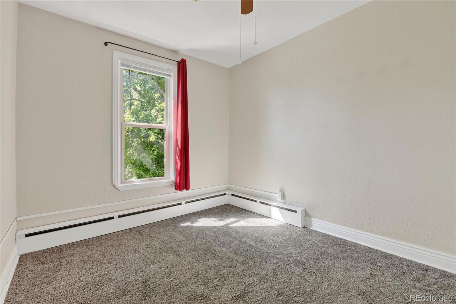 3127 West 28th Avenue, Unit 2 Denver, CO 80211 - Photo 3 of 30 an empty room with a window