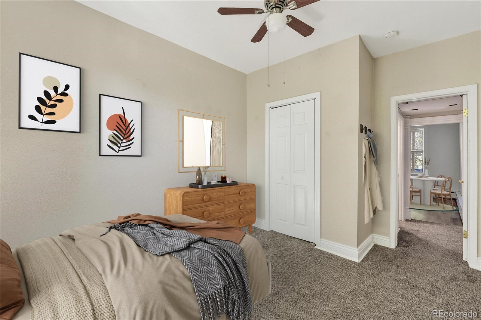 3127 West 28th Avenue, Unit 2 Denver, CO 80211 - Photo 4 of 30 a bedroom with a bed and a chandelier