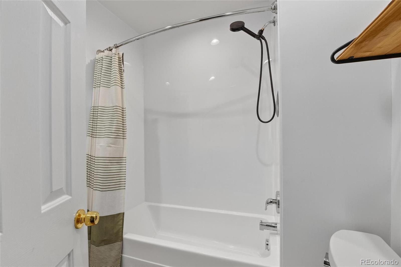 3127 West 28th Avenue, Unit 2 Denver, CO 80211 - Photo 7 of 30 a bathroom with a shower and a bathtub