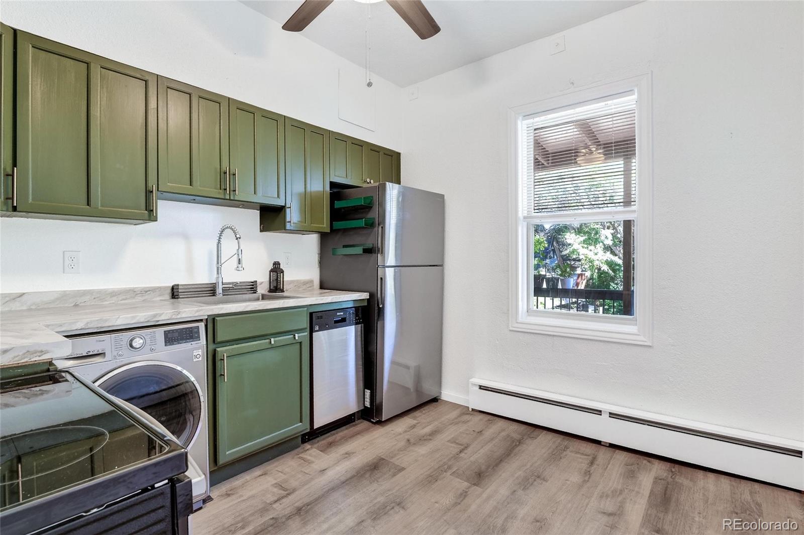 3127 West 28th Avenue, Unit 2 Denver, CO 80211 - Photo 10 of 30 a kitchen with a refrigerator and a sink