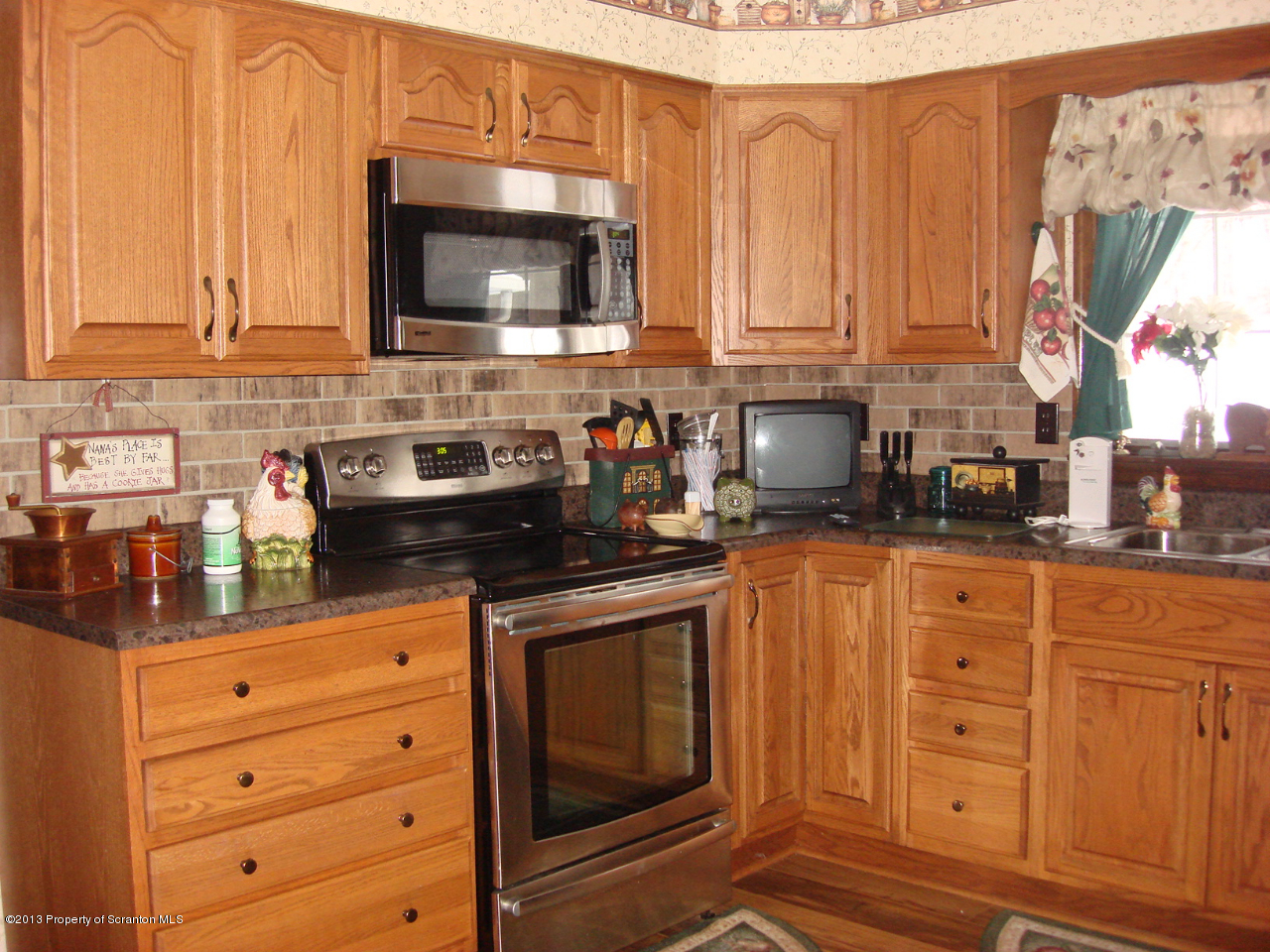 276 Lane Hill Road Tunkhannock, PA 18657 - Photo 5 of 13 a kitchen with granite countertop white cabinets stainless steel appliances and sink