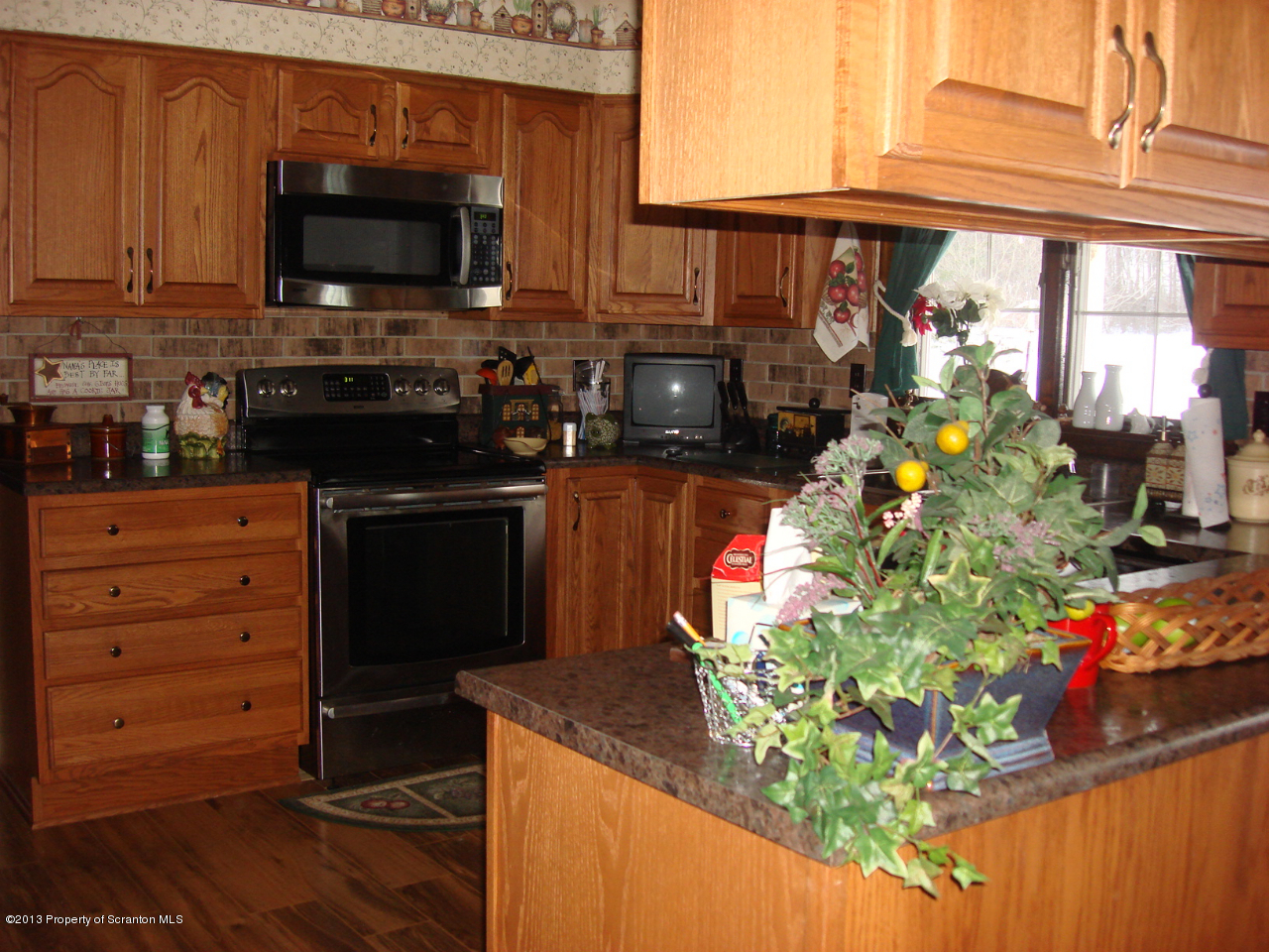276 Lane Hill Road Tunkhannock, PA 18657 - Photo 6 of 13 a kitchen filled with a stove a microwave a sink and cabinets