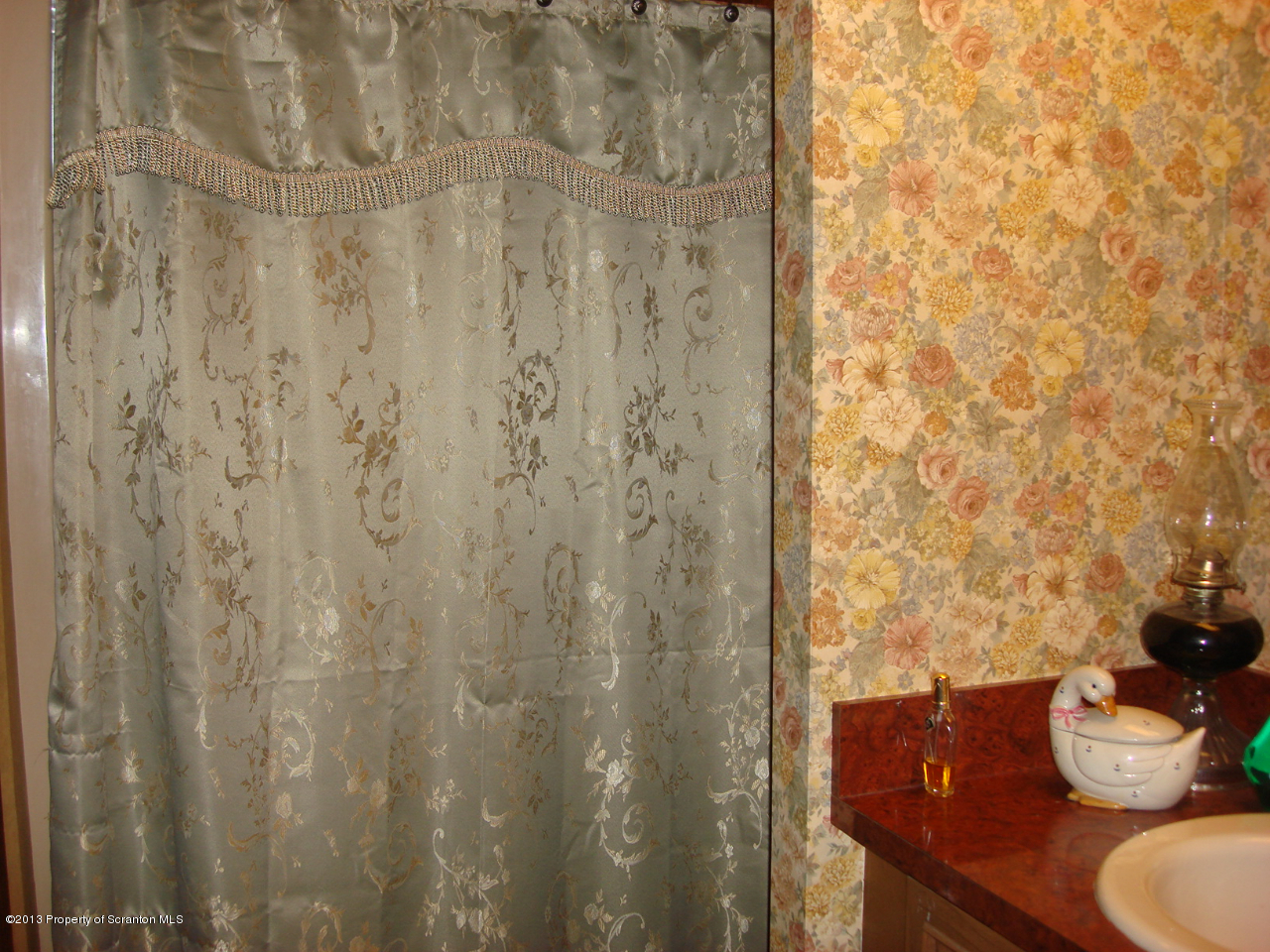 276 Lane Hill Road Tunkhannock, PA 18657 - Photo 9 of 13 a bathroom with a granite countertop sink and a shower curtain