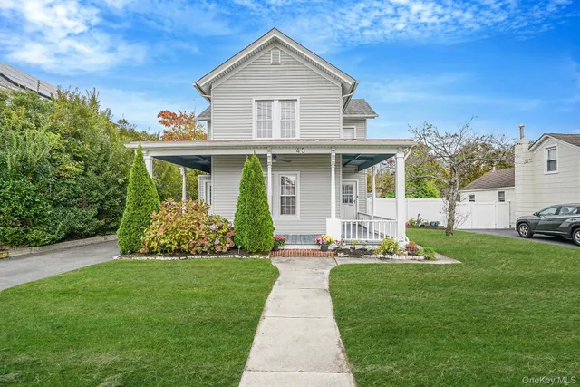 a front view of a house with a yard and porch