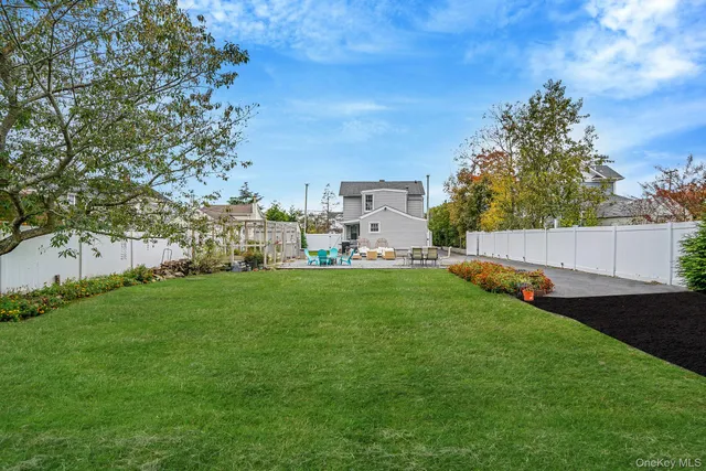 a view of yard with swimming pool and green space