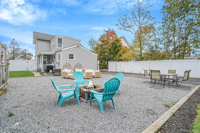 a view of a house with backyard and sitting area