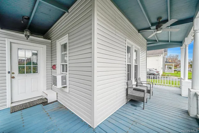 a view of a porch with furniture and wooden floor
