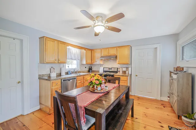 a view of a dining room with furniture and a window